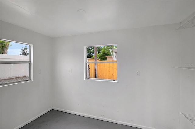 7524 Tidewater Trl, Tampa, FL 33619 - spare room featuring baseboards and concrete floors