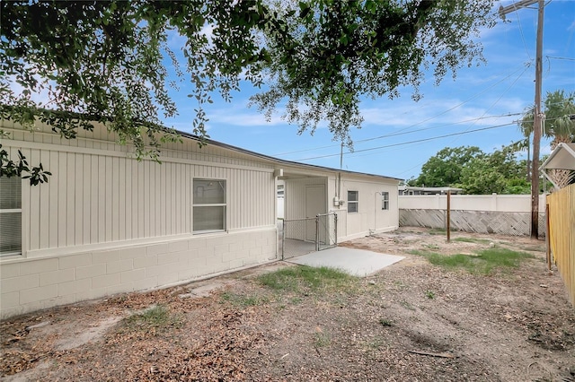 7524 Tidewater Trl, Tampa, FL 33619 - rear view of house featuring a gate and concrete block siding