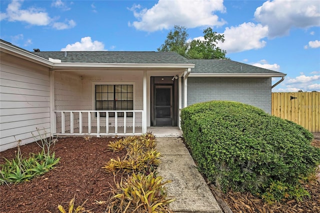 1717 Osprey Ln, Lutz, FL 33549 - doorway to property with covered porch and a shingled roof