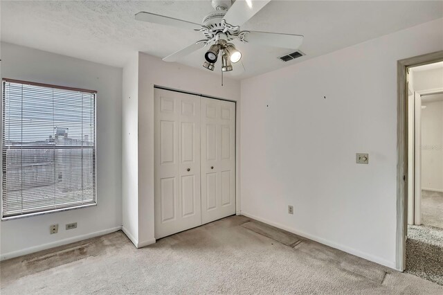 1717 Osprey Ln, Lutz, FL 33549 - unfurnished bedroom with light carpet, a closet, baseboards, and ceiling fan