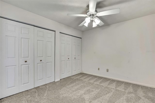 1717 Osprey Ln, Lutz, FL 33549 - unfurnished bedroom featuring carpet flooring, multiple closets, baseboards, and a ceiling fan