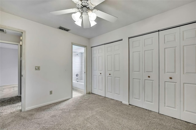 1717 Osprey Ln, Lutz, FL 33549 - unfurnished bedroom with carpet flooring, two closets, baseboards, and connected bathroom