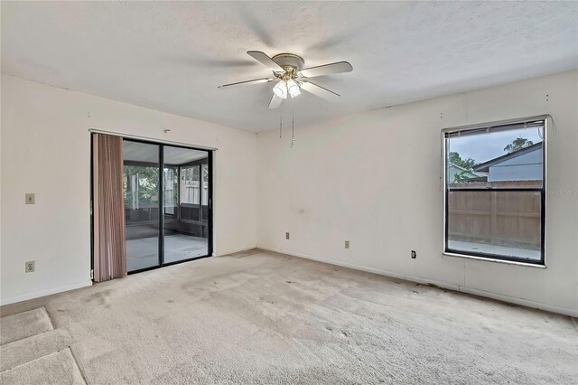 1717 Osprey Ln, Lutz, FL 33549 - unfurnished room featuring healthy amount of natural light, ceiling fan, carpet, and baseboards