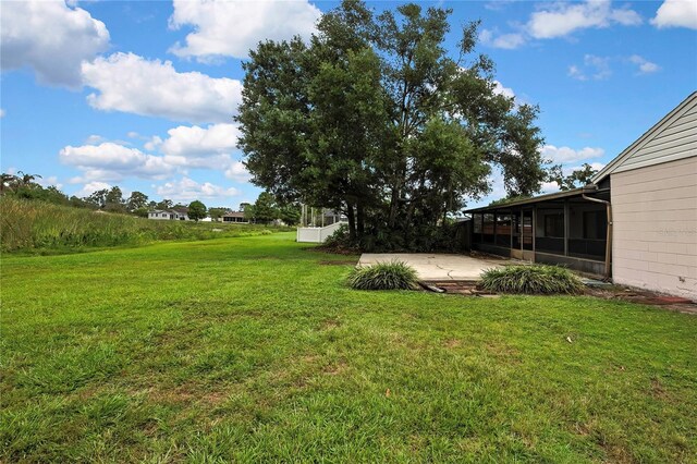 1717 Osprey Ln, Lutz, FL 33549 - view of green lawn featuring a sunroom and a patio area