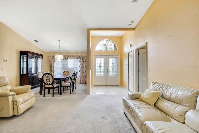 6121 Piedmont Dr, Spring Hill, FL 34606 - living room with light carpet, french doors, a chandelier, and vaulted ceiling