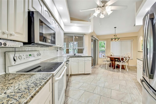 6121 Piedmont Dr, Spring Hill, FL 34606 - kitchen featuring stainless steel appliances, a sink, ceiling fan, backsplash, and hanging light fixtures