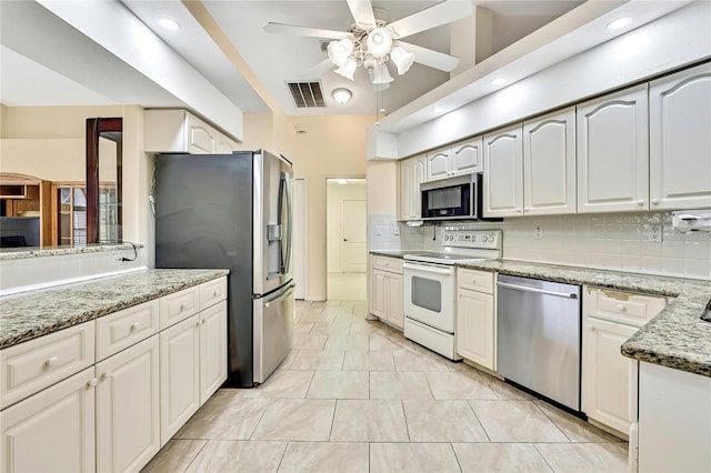 6121 Piedmont Dr, Spring Hill, FL 34606 - kitchen featuring appliances with stainless steel finishes, ceiling fan, light stone counters, tasteful backsplash, and recessed lighting