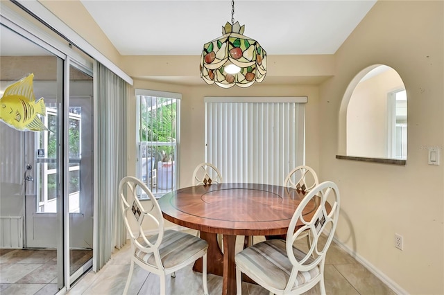 6121 Piedmont Dr, Spring Hill, FL 34606 - dining room with light tile patterned floors and baseboards