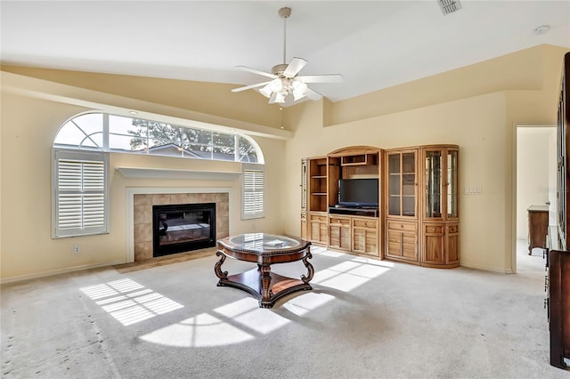 6121 Piedmont Dr, Spring Hill, FL 34606 - carpeted living room with ceiling fan, a fireplace, baseboards, and high vaulted ceiling