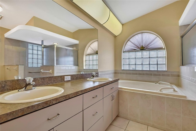 6121 Piedmont Dr, Spring Hill, FL 34606 - full bathroom with double vanity, tile patterned floors, a garden tub, and an enclosed shower