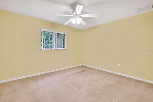 6121 Piedmont Dr, Spring Hill, FL 34606 - spare room with light colored carpet, baseboards, and ceiling fan