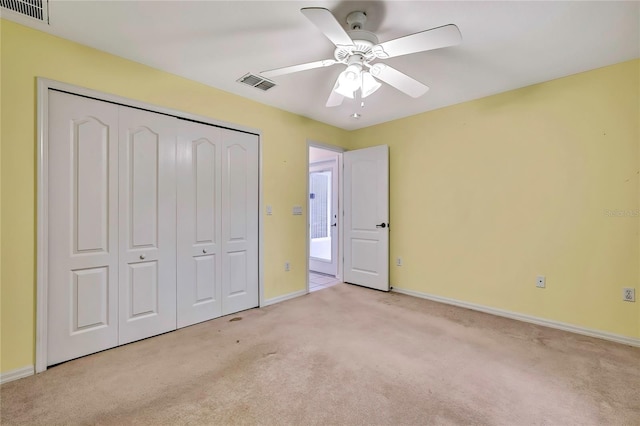 6121 Piedmont Dr, Spring Hill, FL 34606 - unfurnished bedroom featuring light carpet, baseboards, a closet, and a ceiling fan