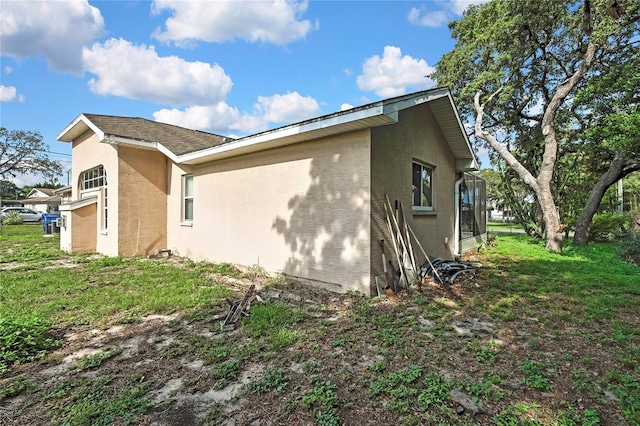 6121 Piedmont Dr, Spring Hill, FL 34606 - view of home's exterior featuring stucco siding and a lawn
