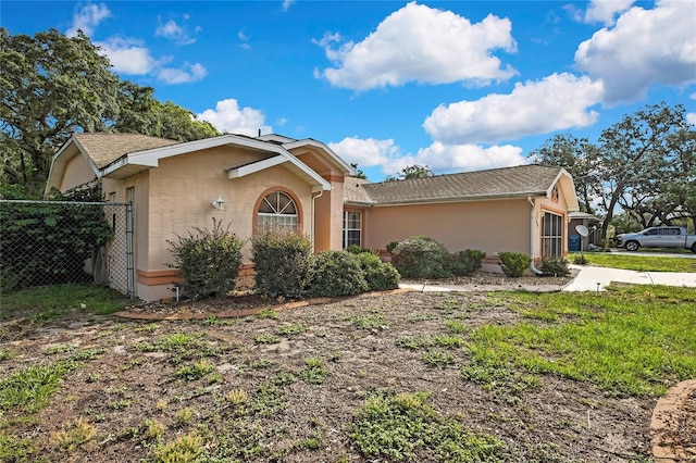 6121 Piedmont Dr, Spring Hill, FL 34606 - view of front of house featuring stucco siding and roof with shingles