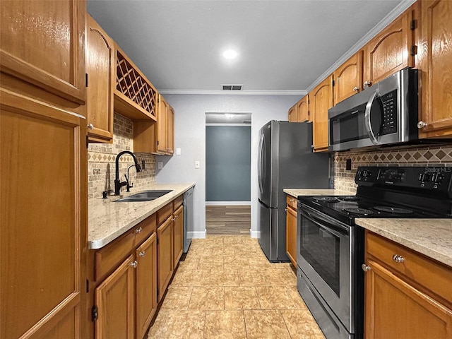 1238 Honeytree Ln E, Lakeland, FL 33801 - kitchen featuring appliances with stainless steel finishes, a sink, decorative backsplash, brown cabinets, and crown molding