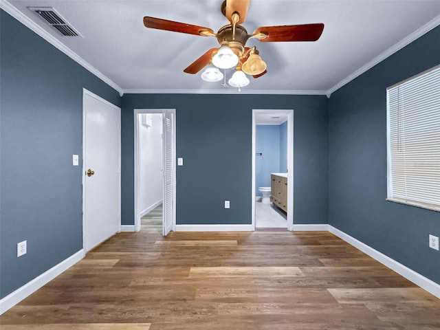 1238 Honeytree Ln E, Lakeland, FL 33801 - spare room with ceiling fan, wood finished floors, ornamental molding, and baseboards