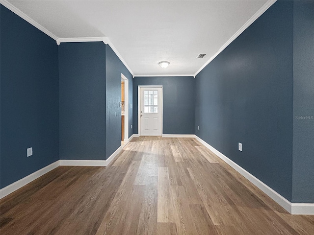 1238 Honeytree Ln E, Lakeland, FL 33801 - empty room featuring wood finished floors, baseboards, and crown molding