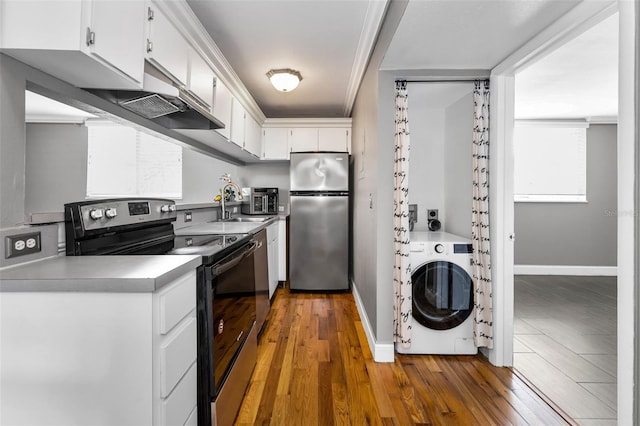 1301 S Howard Ave Unit A22, Tampa, FL 33606 - kitchen featuring appliances with stainless steel finishes, washer / dryer, under cabinet range hood, white cabinetry, and baseboards