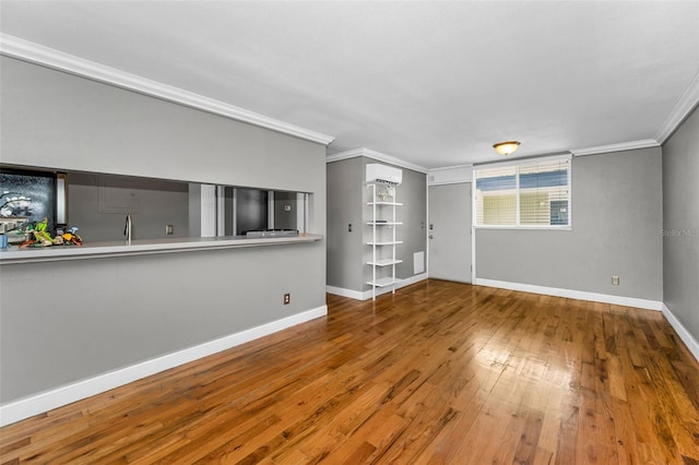 1301 S Howard Ave Unit A22, Tampa, FL 33606 - spare room with ornamental molding, hardwood / wood-style floors, a wall mounted AC, and baseboards
