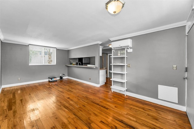 1301 S Howard Ave Unit A22, Tampa, FL 33606 - unfurnished living room with crown molding, a wall unit AC, hardwood / wood-style flooring, and baseboards