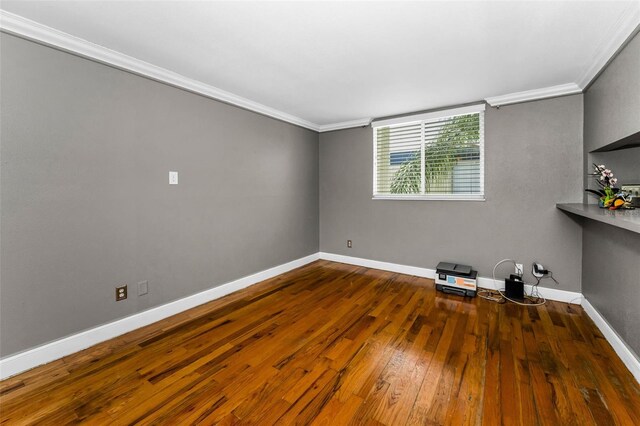 1301 S Howard Ave Unit A22, Tampa, FL 33606 - spare room featuring ornamental molding, hardwood / wood-style flooring, and baseboards