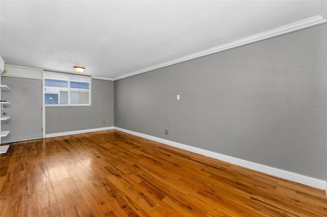 1301 S Howard Ave Unit A22, Tampa, FL 33606 - unfurnished bedroom featuring ornamental molding, baseboards, and wood-type flooring