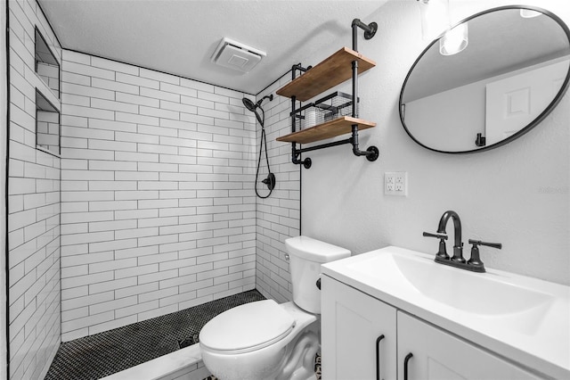 1301 S Howard Ave Unit A22, Tampa, FL 33606 - full bathroom featuring toilet, vanity, tiled shower, and a textured ceiling