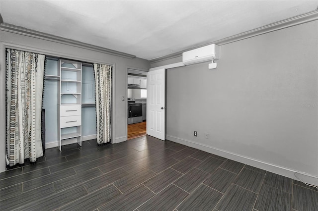 1301 S Howard Ave Unit A22, Tampa, FL 33606 - unfurnished bedroom featuring a wall unit AC, baseboards, wood tiled floors, and a closet