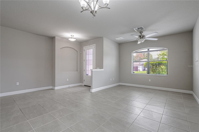 19974 Bluebird Meadow Dr, Lutz, FL 33558 - spare room featuring light tile patterned flooring, a chandelier, a ceiling fan, and a textured ceiling