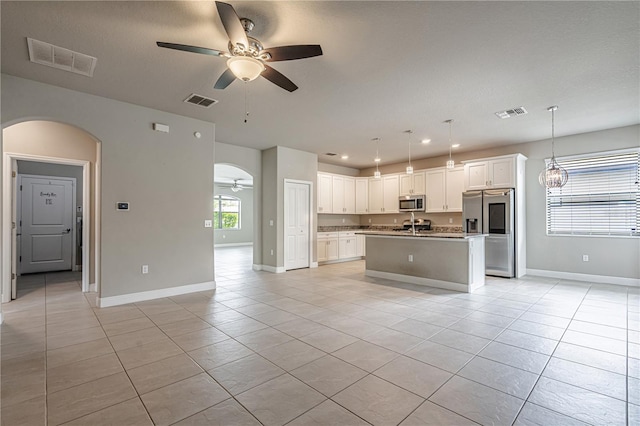 19974 Bluebird Meadow Dr, Lutz, FL 33558 - kitchen featuring appliances with stainless steel finishes, a ceiling fan, arched walkways, open floor plan, and recessed lighting