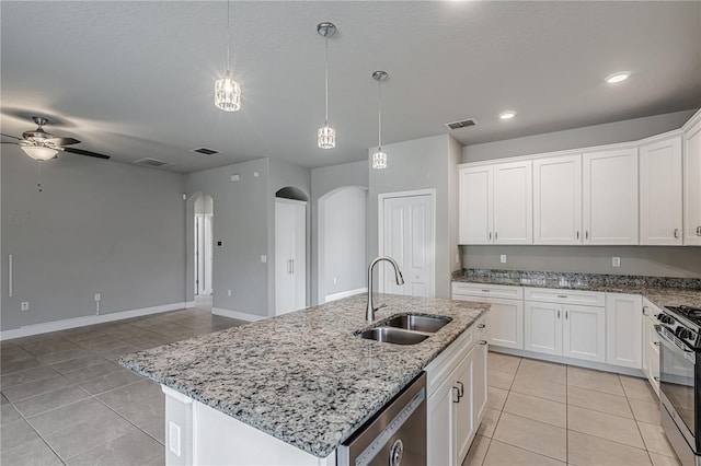 19974 Bluebird Meadow Dr, Lutz, FL 33558 - kitchen featuring appliances with stainless steel finishes, light tile patterned floors, arched walkways, open floor plan, and a ceiling fan