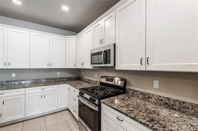 19974 Bluebird Meadow Dr, Lutz, FL 33558 - kitchen with stainless steel appliances, white cabinets, light tile patterned floors, dark stone countertops, and recessed lighting