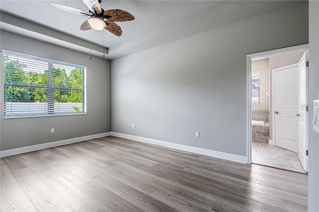 19974 Bluebird Meadow Dr, Lutz, FL 33558 - spare room with ceiling fan, a textured ceiling, and light wood-type flooring