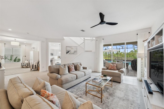 32490 Tree Of Life Ave, Wesley Chapel, FL 33543 - living area with ceiling fan, stairway, light tile patterned flooring, recessed lighting, and baseboards