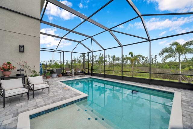 32490 Tree Of Life Ave, Wesley Chapel, FL 33543 - swimming pool with a patio and glass enclosure