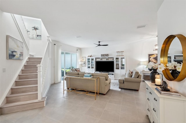 32490 Tree Of Life Ave, Wesley Chapel, FL 33543 - living room featuring ceiling fan, stairway, and light tile patterned floors