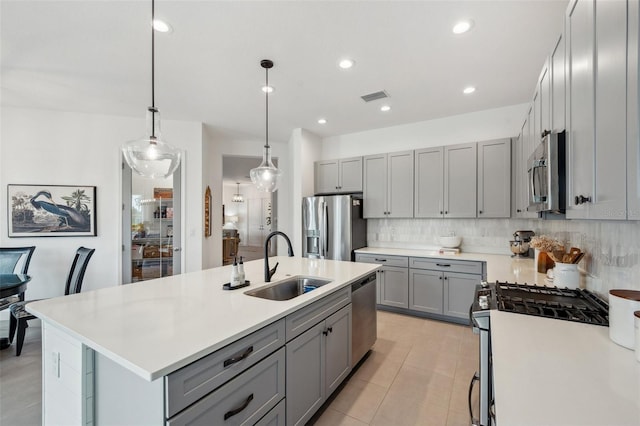 32490 Tree Of Life Ave, Wesley Chapel, FL 33543 - kitchen featuring appliances with stainless steel finishes, gray cabinets, a sink, a kitchen island with sink, and recessed lighting