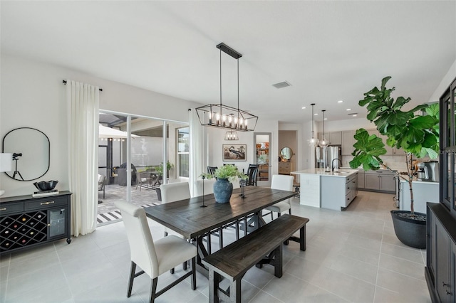 32490 Tree Of Life Ave, Wesley Chapel, FL 33543 - dining room with light tile patterned flooring, a chandelier, and recessed lighting