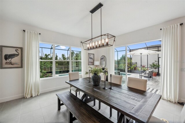 32490 Tree Of Life Ave, Wesley Chapel, FL 33543 - dining room featuring baseboards, healthy amount of natural light, a chandelier, and light tile patterned flooring
