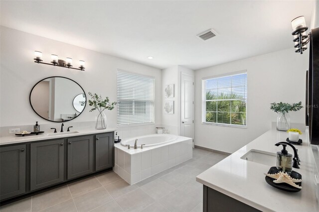 32490 Tree Of Life Ave, Wesley Chapel, FL 33543 - bathroom featuring two vanities, tile patterned floors, and a bath