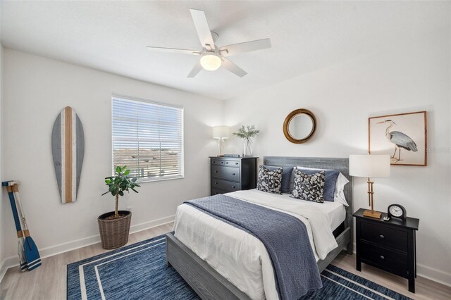 32490 Tree Of Life Ave, Wesley Chapel, FL 33543 - bedroom with wood finished floors, baseboards, and ceiling fan