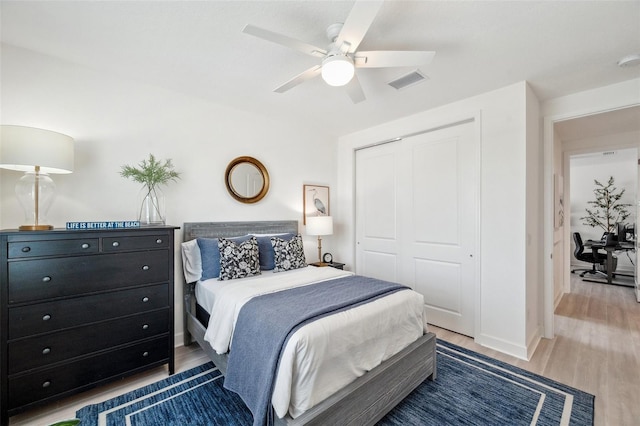 32490 Tree Of Life Ave, Wesley Chapel, FL 33543 - bedroom with light wood-type flooring, a closet, a ceiling fan, and baseboards