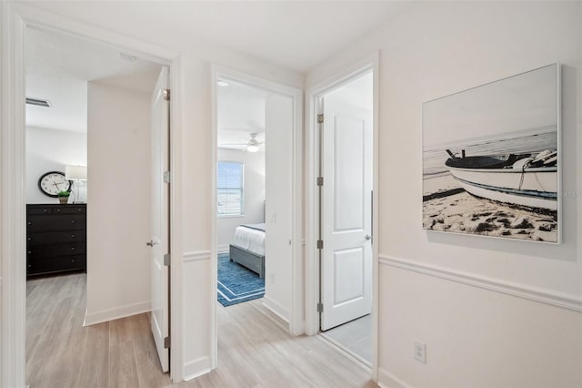32490 Tree Of Life Ave, Wesley Chapel, FL 33543 - hall featuring wood finished floors and baseboards