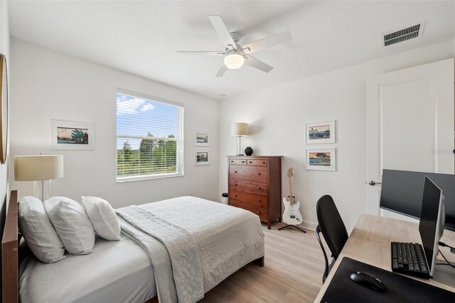 32490 Tree Of Life Ave, Wesley Chapel, FL 33543 - bedroom with light wood finished floors, ceiling fan, baseboards, and an office area