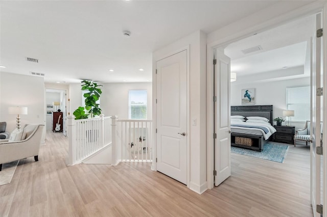 32490 Tree Of Life Ave, Wesley Chapel, FL 33543 - hallway with light wood-style flooring, baseboards, recessed lighting, and an upstairs landing