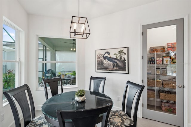 32490 Tree Of Life Ave, Wesley Chapel, FL 33543 - tiled dining space featuring a chandelier and baseboards