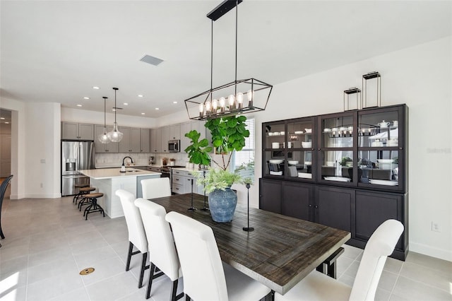 32490 Tree Of Life Ave, Wesley Chapel, FL 33543 - dining room with a chandelier, light tile patterned floors, baseboards, and recessed lighting