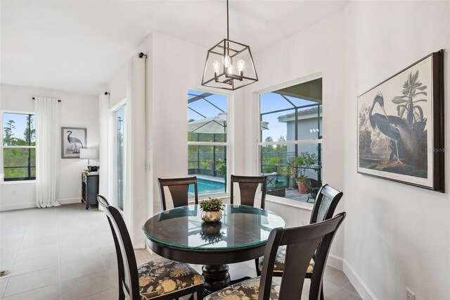32490 Tree Of Life Ave, Wesley Chapel, FL 33543 - dining room featuring a chandelier, baseboards, and light tile patterned floors