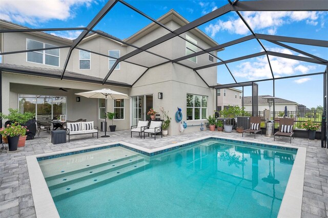 32490 Tree Of Life Ave, Wesley Chapel, FL 33543 - rear view of property with a patio, an outdoor pool, stucco siding, and a lanai