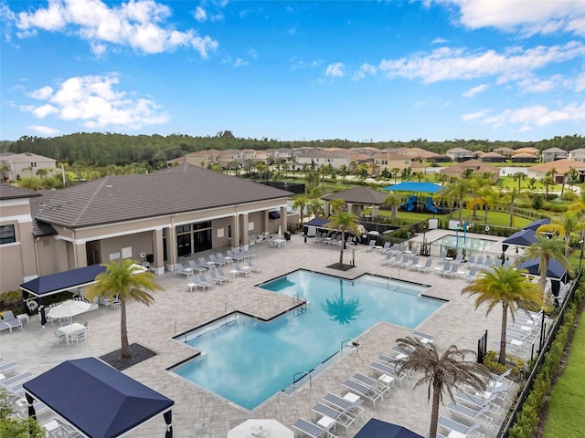 32490 Tree Of Life Ave, Wesley Chapel, FL 33543 - community pool featuring a residential view and a patio area